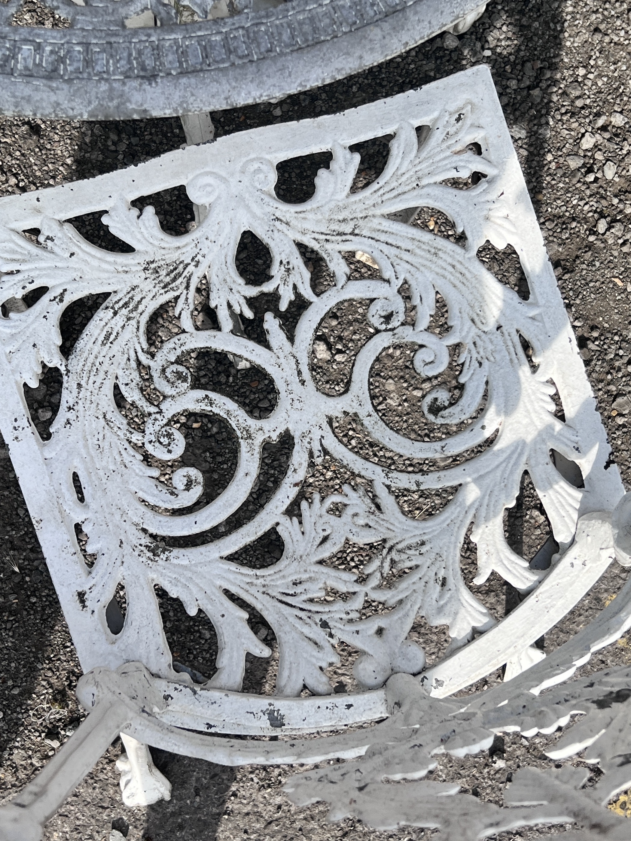 A Victorian style circular painted aluminium garden table, diameter 72cm, height 65cm, and three chairs